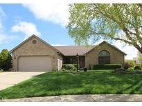 Charming brick ranch home with well-manicured lawn, mature trees, and two car garage at 421 Kingsway Ct, Mooresville, IN 46158