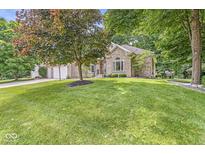 Charming single-story brick home with a well-manicured lawn and mature trees at 545 Pitney Dr, Noblesville, IN 46062