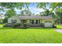 Charming single-story home with a well-manicured lawn and inviting curb appeal, perfect for suburban living at 7600 S Oak Dr, Indianapolis, IN 46227