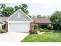Charming single Gathering home featuring a two-car garage, a well-manicured lawn, and lovely red roses at 7686 Micawber Ct, Indianapolis, IN 46256