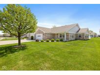 Charming brick home with well-manicured lawn and mature landscaping at 7687 Sea Crest N Way, Noblesville, IN 46062