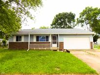 Charming ranch-style home with a well-manicured lawn and an attached one-car garage at 8609 Stonewall Dr, Indianapolis, IN 46231