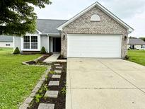 Charming single-Gathering home with a well-maintained lawn, brick accents, and a two-car garage at 883 Halyard Dr, Avon, IN 46123