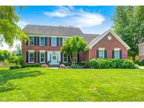 Charming two-story brick home with a well-manicured lawn and traditional architectural details at 10717 Windermere Blvd, Fishers, IN 46037