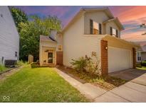Charming two-story home features a brick accent, a well-manicured lawn, and an attached two-car garage at 1139 Maple Stream Dr, Indianapolis, IN 46217