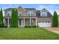 Charming brick two-story home with manicured lawn and curb appeal at 1143 Hampton Dr, Greenwood, IN 46143