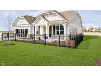 Charming home with a well-manicured lawn and black iron fence at 138 Rock Island Rd, Westfield, IN 46069