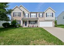 Charming two-story home with brick facade, well-manicured lawn, and inviting front porch at 1744 Salina Dr, Avon, IN 46123