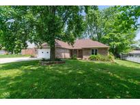 Charming brick home with a well-manicured lawn and mature tree in a desirable neighborhood at 180 Hollowview Dr, Noblesville, IN 46060