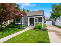 Charming home with a welcoming front porch, landscaped lawn, and detached garage at 188 Maple Ln, Franklin, IN 46131