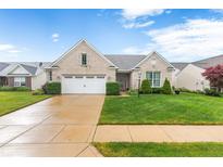 Charming brick ranch home with a well-manicured lawn and two car garage at 18991 Round Lake Rd, Noblesville, IN 46060