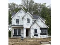 Two-story home in progress featuring black-framed windows and a peaked roof design at 21025 Thornborough Dr, Westfield, IN 46074
