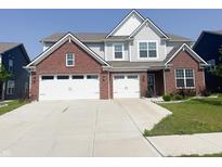 Two-story home featuring a brick-accented facade, light gray siding, and a spacious two-car garage at 2358 S Stonehill Way, New Palestine, IN 46163