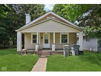 Charming single-Gathering home featuring a welcoming front porch and well-maintained lawn at 3028 Hovey St, Indianapolis, IN 46218