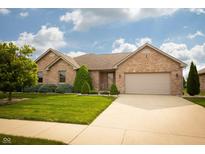 Charming brick home with a well-manicured lawn and a two-car garage at 3717 Bellmore Dr, Brownsburg, IN 46112