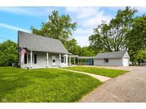 Charming two-story home with spacious front yard, detached garage and ample parking at 379 N Marion St, Morgantown, IN 46160