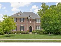 Beautiful two-story brick home with manicured lawn and professional landscaping at 4529 Panthera Leo Dr, Carmel, IN 46074