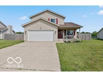 Inviting two-story home with a well-manicured lawn and a convenient two-car garage at 4605 Clairmont Dr, Columbus, IN 47203