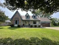 Charming two-story home featuring a welcoming front porch and well-manicured lawn at 530 Denny Dr, Mooresville, IN 46158