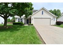 Charming two-story home featuring a two-car garage, well-maintained lawn, and mature tree at 5456 Reston Dr, Plainfield, IN 46168