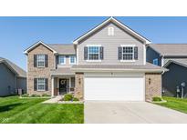 Two-story home featuring a two-car garage, brick accents, and a well-manicured lawn at 5794 Cherrywood Ln, McCordsville, IN 46055