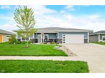 Charming single-story home with a manicured front yard, stone accents, and a two-car garage at 655 N Sobota Way, Trafalgar, IN 46181