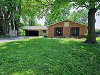 Charming single-story brick home with well-maintained lawn and detached garage at 6801 Shalimar Ct, Indianapolis, IN 46214
