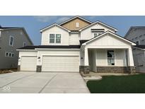 Beautiful two-story home with a two-car garage and a well-manicured lawn at 7151 Firestone Rd, Whitestown, IN 46052