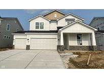 New construction two-story home boasting a three car garage, white siding, and contrasting stone foundation at 7151 Firestone Rd, Whitestown, IN 46052