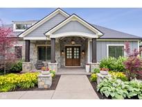 Stunning front entrance featuring a stone facade, wood columns, and a beautifully landscaped walkway at 780 Chatham Hills Blvd, Westfield, IN 46074