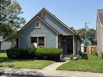 Charming blue bungalow home with a well-maintained lawn and inviting front entrance at 812 N California St, Indianapolis, IN 46202