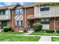 A brick townhome featuring a well-maintained front yard and a charming entrance at 8121 Bromley Pl, Indianapolis, IN 46219