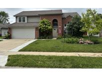 Charming two-story brick home with a well-manicured lawn and inviting curb appeal at 8926 Durban Ct, Indianapolis, IN 46234