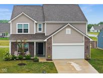 Charming two-story home featuring a well-manicured lawn and an attached two-car garage at 10118 Falls Canyon Ln, Indianapolis, IN 46229