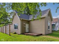 Charming single-story home with tan siding and a well-manicured lawn, showcasing curb appeal at 1106 N Sheffield Ave, Indianapolis, IN 46222