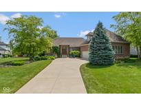 Charming brick home featuring a well-manicured lawn and a long driveway leading to an attached garage at 11761 Darsley Dr, Fishers, IN 46037