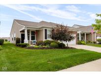 Charming home featuring beautiful landscaping, a welcoming front porch, and a well-maintained lawn at 12820 Gloria Dr, Fishers, IN 46037