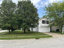 Two-story home with white siding, an attached two-car garage, and a lush green lawn at 1294 Kenwood Dr, Greenwood, IN 46143