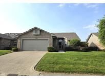Charming one-story brick home with attached two-car garage and well-manicured lawn at 1311 Aaron Dr, Shelbyville, IN 46176