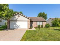 Charming single-story home featuring a well-manicured lawn, brick accents, and an attached two-car garage at 1450 Millridge Dr, Greenwood, IN 46143