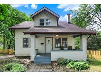 Charming two-story home with a covered front porch, landscaped yard, and classic architectural details at 1511 E Edwards Ave, Indianapolis, IN 46227