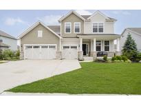Charming two-story home with a well-manicured lawn, two-car garage and inviting front porch at 15598 Memorial Way, Fishers, IN 46037