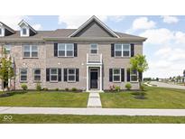 Charming brick townhouse with black shutters and a well-manicured lawn, perfect for modern living at 2892 Maricopa Blvd, Whitestown, IN 46075