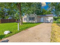 Charming one-story home with a well-maintained lawn, concrete driveway, and inviting curb appeal at 3817 Strathmore Dr, Indianapolis, IN 46235