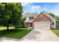 Charming two-story home featuring a brick accent, attached two-car garage, and a well-manicured front yard at 3823 Vanguard Cir, Carmel, IN 46032