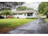Charming one-story home featuring a well-manicured lawn and asphalt driveway at 4020 Alden Ave, Indianapolis, IN 46221