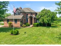 Charming two-story brick home featuring an inviting front yard and an American flag at 4287 Gibbs Rd, Danville, IN 46122
