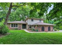 Charming two-story home features brick accents, lush landscaping and a welcoming front entrance at 4570 Moccosin Pl, Greenwood, IN 46142