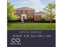 Charming red brick home featuring a well-manicured lawn and mature trees with an open house banner displayed at 4617 S Cobblestone Dr, Zionsville, IN 46077