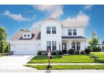 Charming two-story home with a manicured lawn, a two-car garage, and a covered front porch at 4992 Fennel Dr, Pittsboro, IN 46167